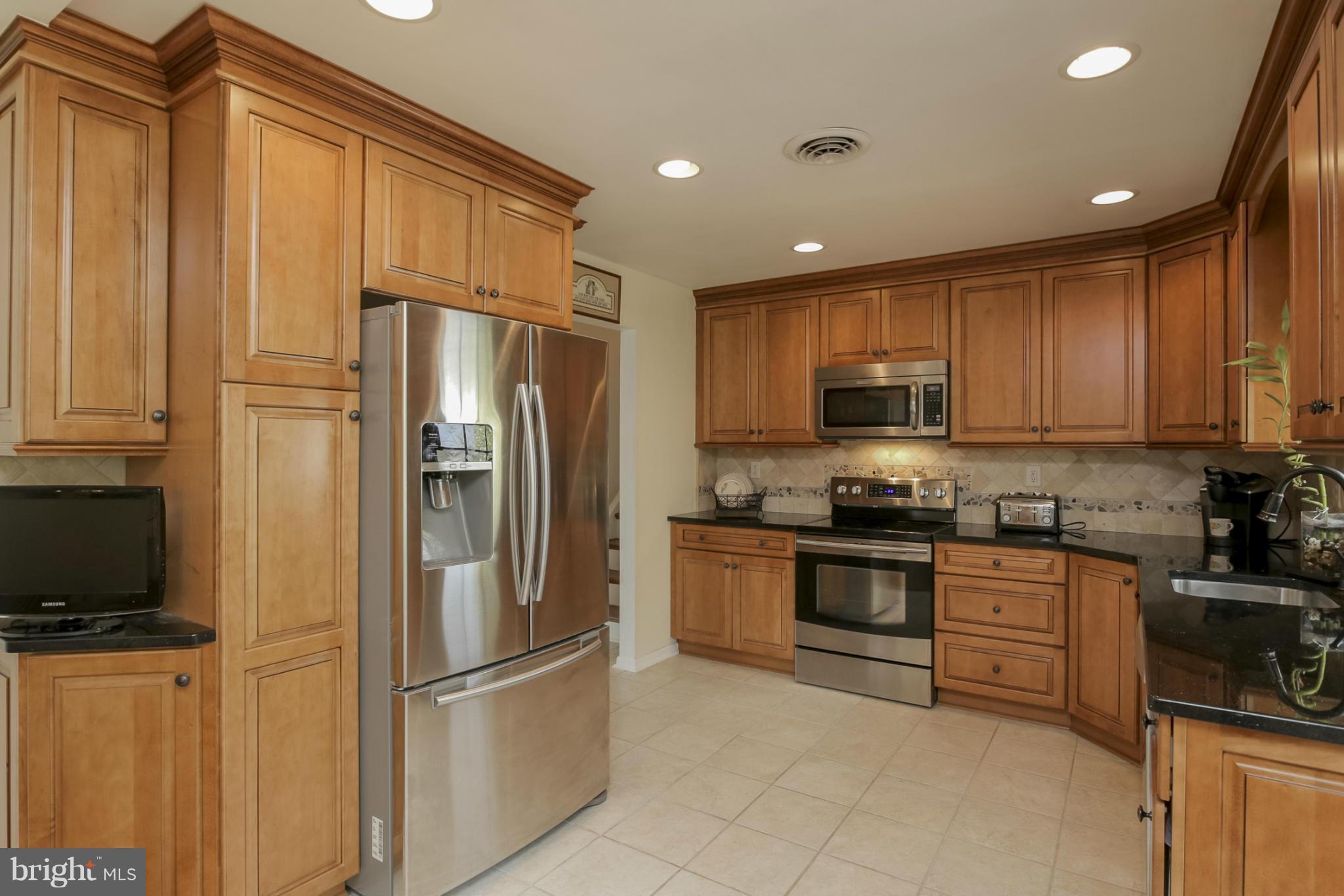 1111 Peachtree Road Fallston, MD 21047 - Photo 9 of 30 a kitchen with stainless steel appliances granite countertop a refrigerator a stove top oven a sink and dishwasher