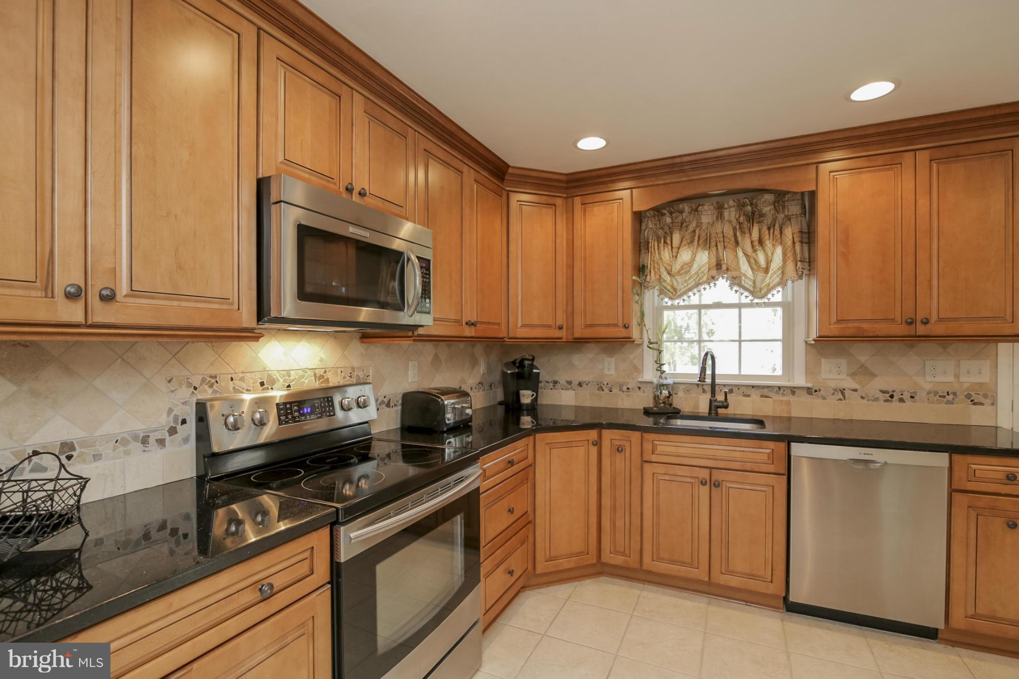 1111 Peachtree Road Fallston, MD 21047 - Photo 10 of 30 a kitchen with a sink stove and microwave