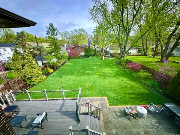 a view of yard with swimming pool and green space