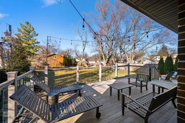 a view of a roof deck with couches and wooden floor