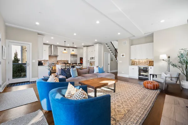 a living room with furniture and kitchen view