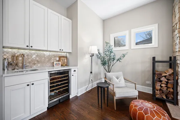 a kitchen with stainless steel appliances white cabinets and wooden floor