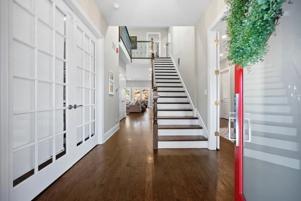 a view of a hallway with wooden floor and entryway