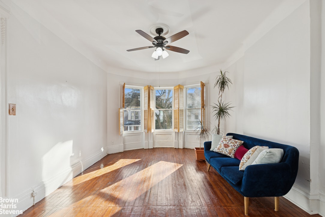 251 Rutland Road Brooklyn, NY 11225 - Photo 2 of 16 a living room with furniture and a window