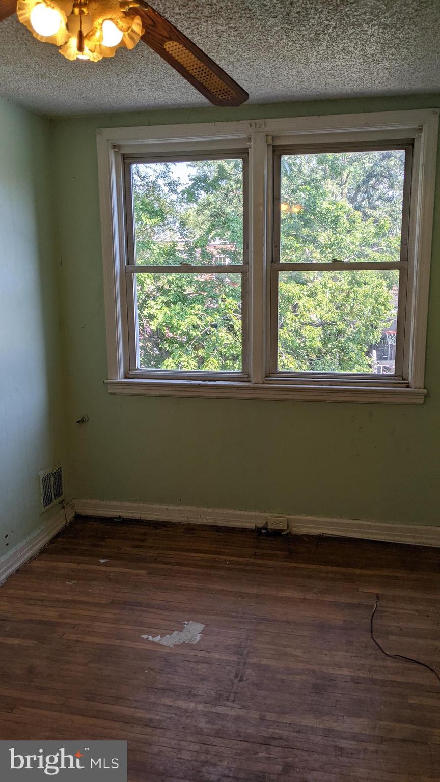 3162 Colorado Road Camden, NJ 08104 - Photo 14 of 21 an empty room with wooden floor and windows