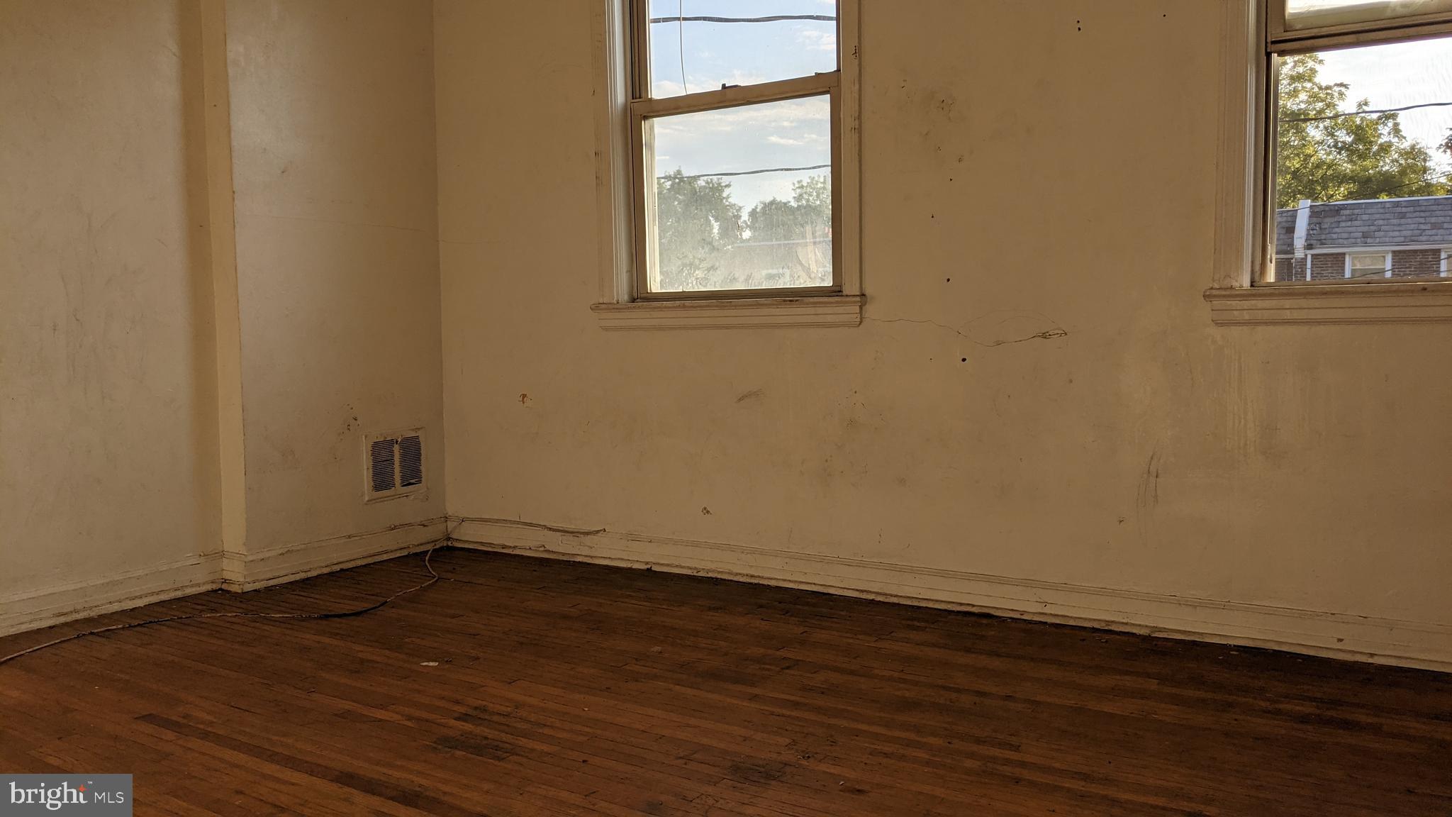 3162 Colorado Road Camden, NJ 08104 - Photo 17 of 21 an empty room with wooden floor and windows