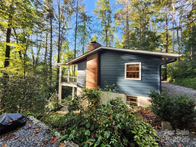 a front view of a house with plants