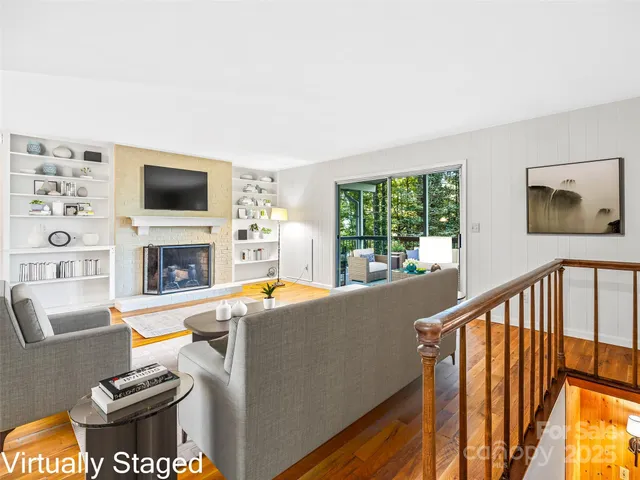 a living room with fireplace furniture and a flat screen tv