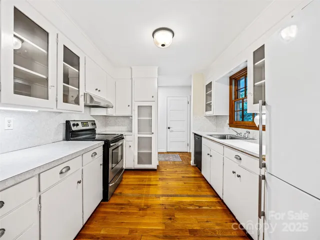a large kitchen with stainless steel appliances granite countertop a stove and a sink
