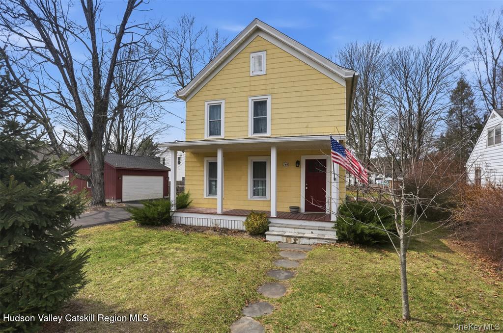 745 Springtown Road Tillson, NY 12486 - Photo 1 of 29 a front view of a house with garden