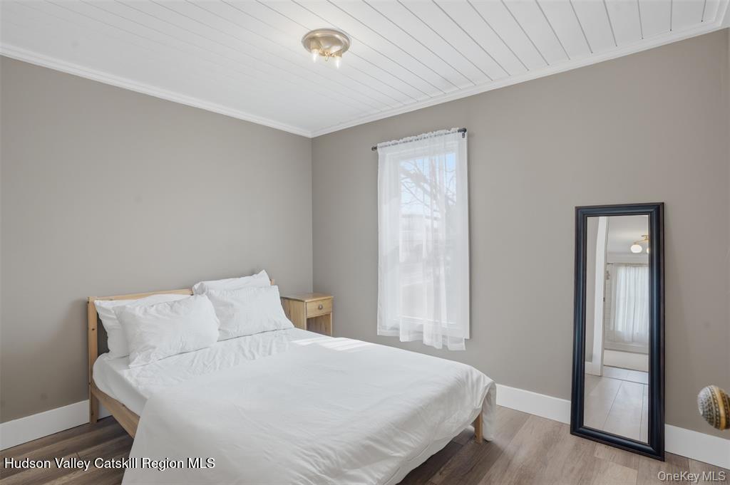 745 Springtown Road Tillson, NY 12486 - Photo 14 of 29 a bedroom with a bed and a mirror