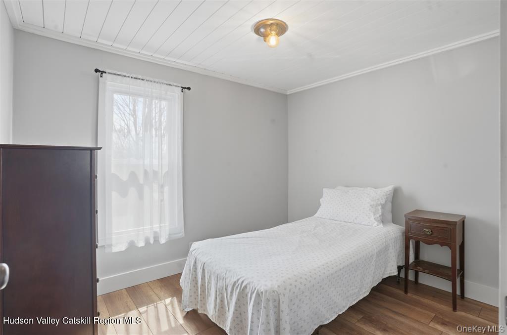 745 Springtown Road Tillson, NY 12486 - Photo 15 of 29 a bedroom with a bed and a table
