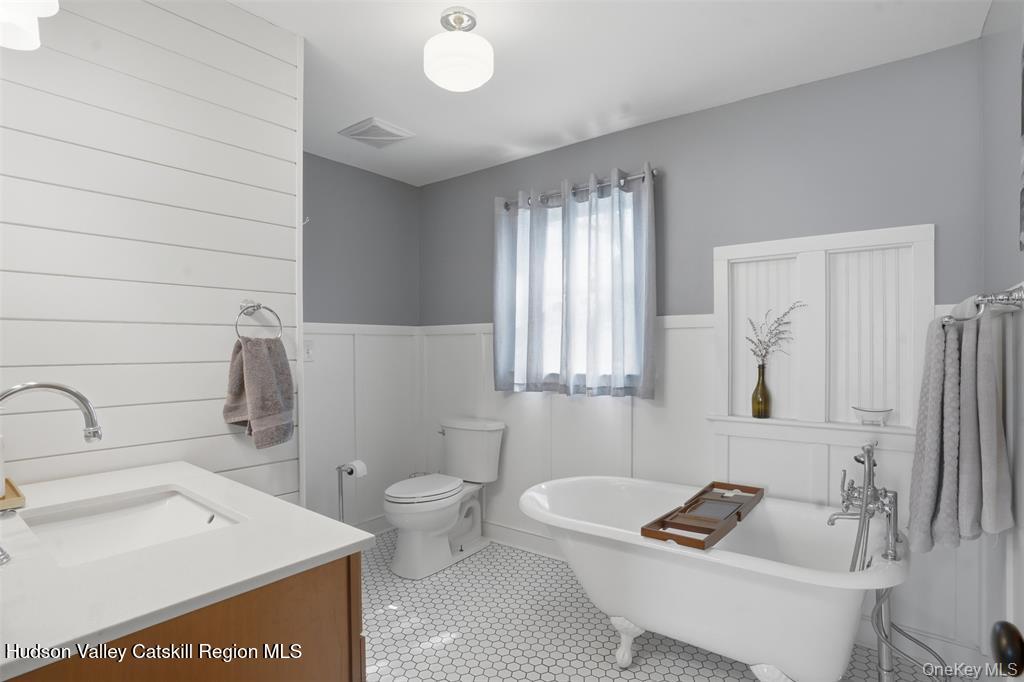 745 Springtown Road Tillson, NY 12486 - Photo 17 of 29 a bathroom with a sink a toilet and a bathtub