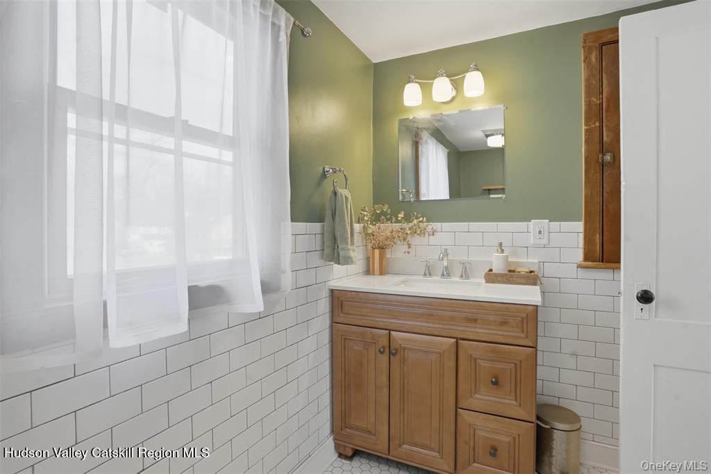 745 Springtown Road Tillson, NY 12486 - Photo 18 of 29 a bathroom with a granite countertop sink and a mirror