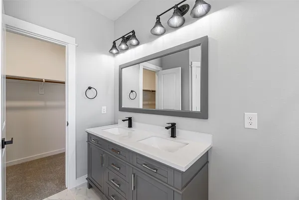 a bathroom with a sink vanity and a mirror