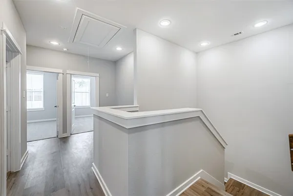 a view of storage and utility room with wooden floor
