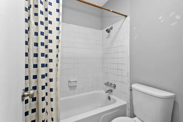 a bathroom with a bathtub and a toilet