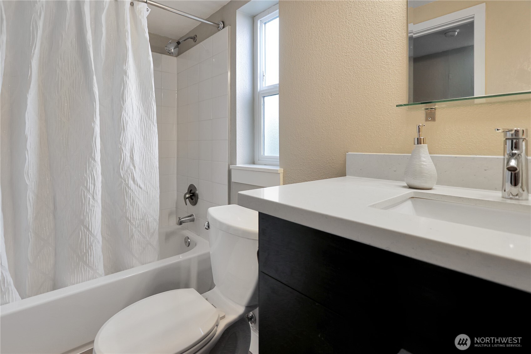1533 18th Avenue South, Unit 5 Seattle, WA 98144 - Photo 5 of 20 a bathroom with a sink a toilet a mirror and shower