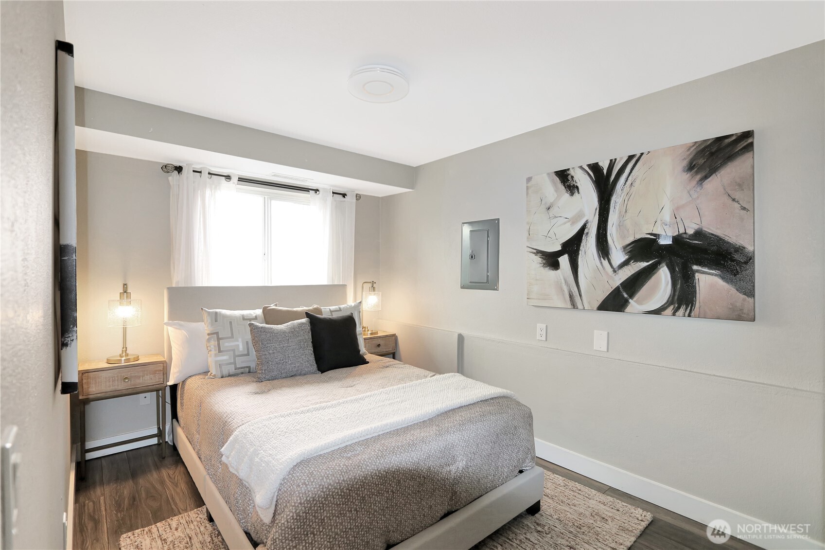 1533 18th Avenue South, Unit 5 Seattle, WA 98144 - Photo 6 of 20 a bedroom with a bed and a painting on the wall