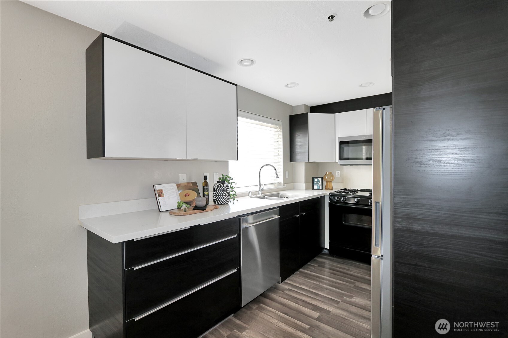 1533 18th Avenue South, Unit 5 Seattle, WA 98144 - Photo 8 of 20 a kitchen with stainless steel appliances granite countertop a sink stove and cabinets