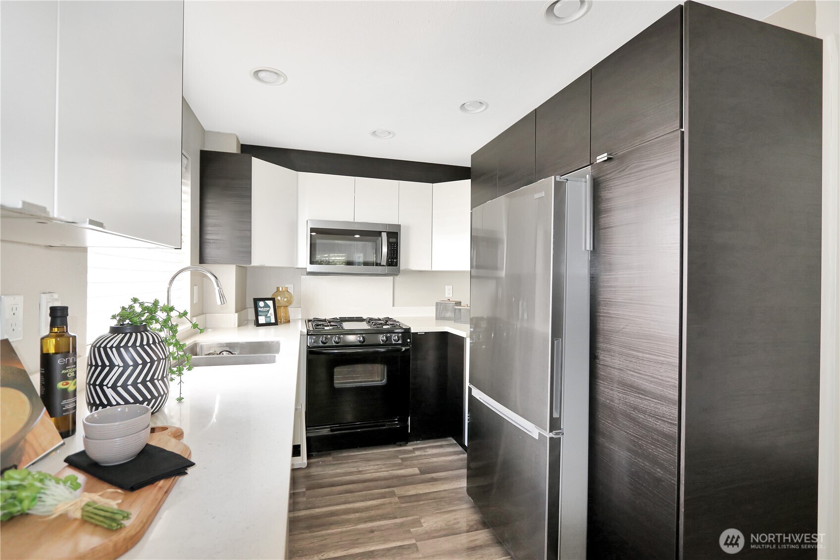 1533 18th Avenue South, Unit 5 Seattle, WA 98144 - Photo 10 of 20 a kitchen with granite countertop stainless steel appliances and a refrigerator