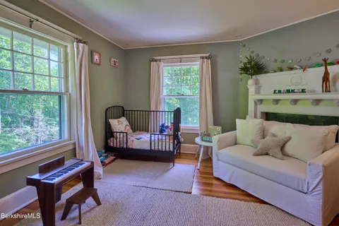 an empty room with furniture and wooden floor