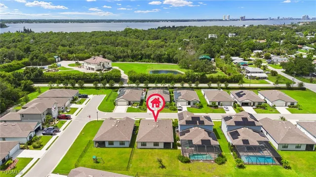 an aerial view of residential houses with outdoor space and street view