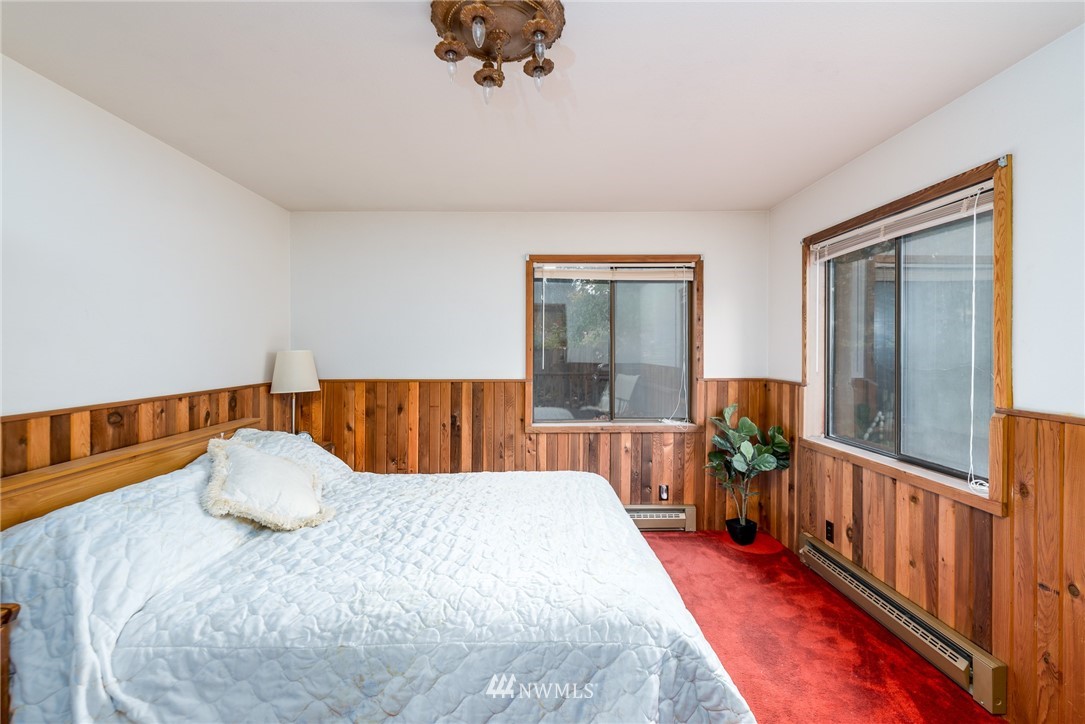 6130 North Fork Road Deming, WA 98244 - Photo 13 of 22 a bedroom with a bed and wooden floor