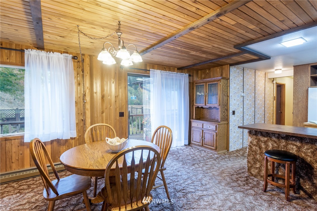 6130 North Fork Road Deming, WA 98244 - Photo 17 of 22 a view of a dining room with furniture and chandelier