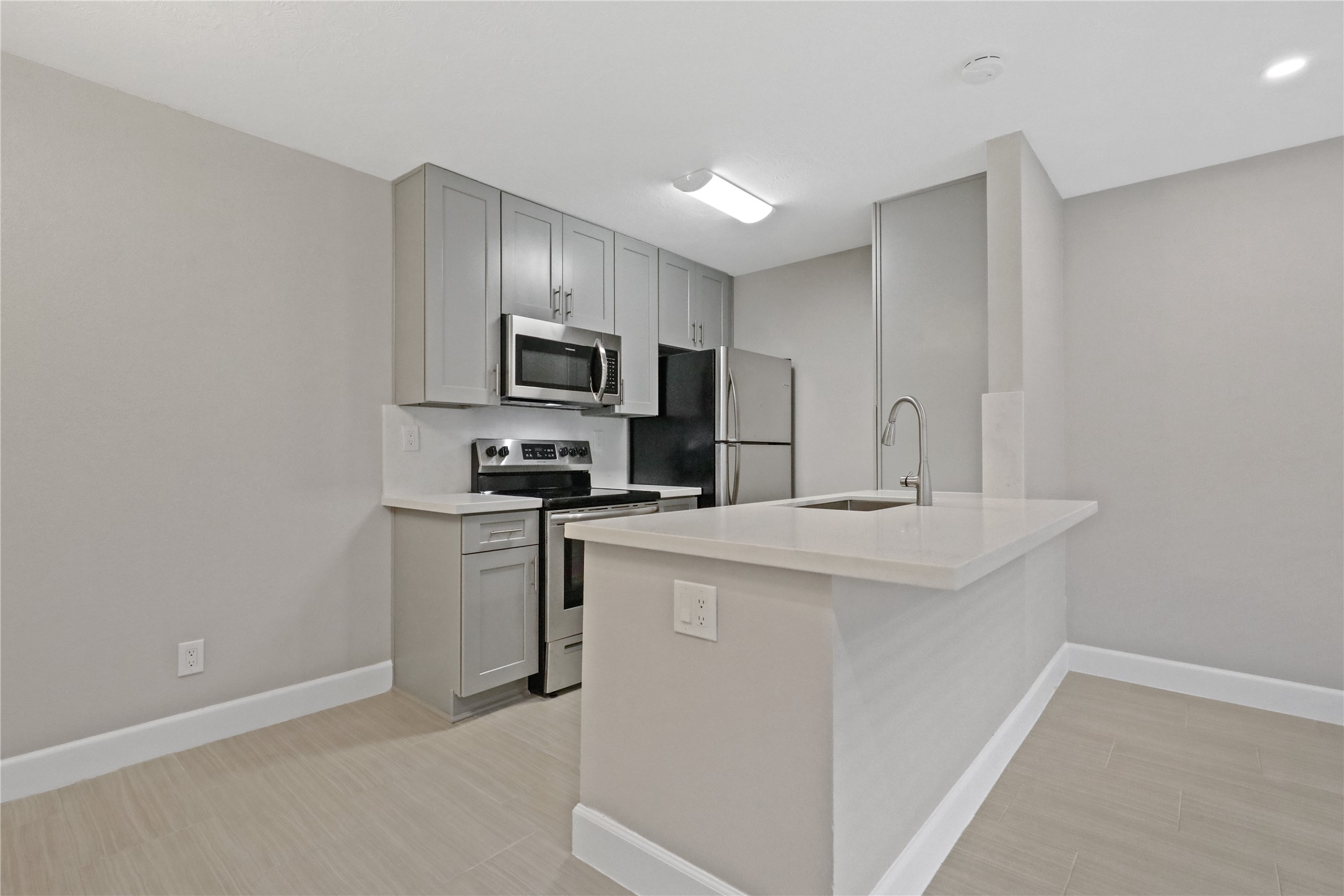 a kitchen with kitchen island a sink stainless steel appliances and cabinets