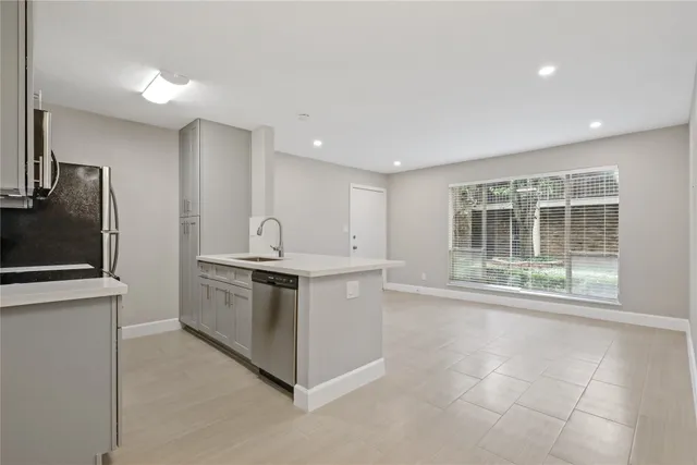 a kitchen with stainless steel appliances granite countertop a stove and a sink