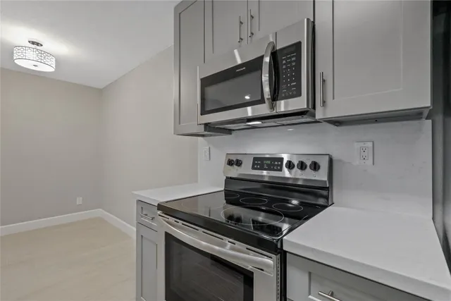 a stove top oven sitting inside of a kitchen