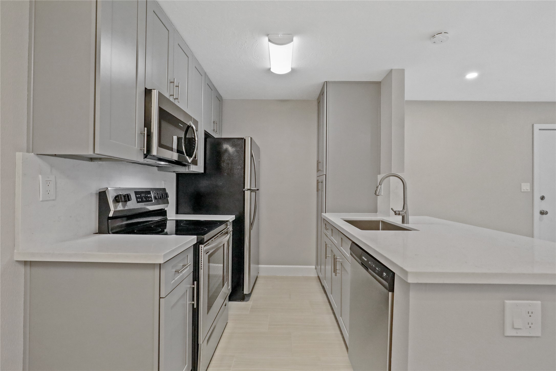 2201 Fountain View Drive, Unit 45 Houston, TX 77057 - Photo 4 of 11 a kitchen with stainless steel appliances granite countertop a sink stove and refrigerator