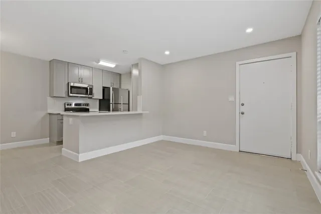 a view of a kitchen with electric appliances