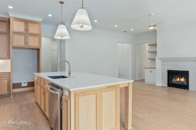 a kitchen with a table and a fireplace in it