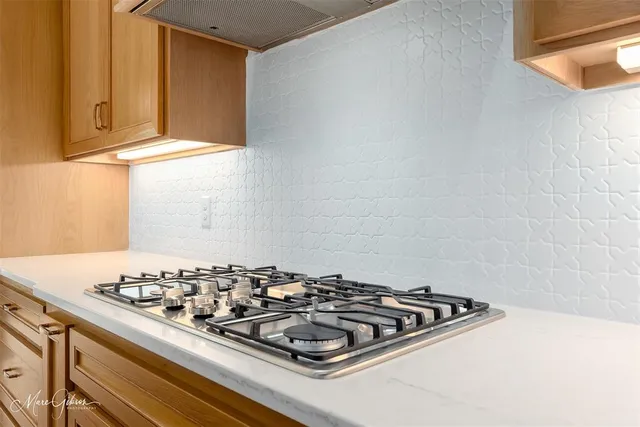 a kitchen with a stove and a window
