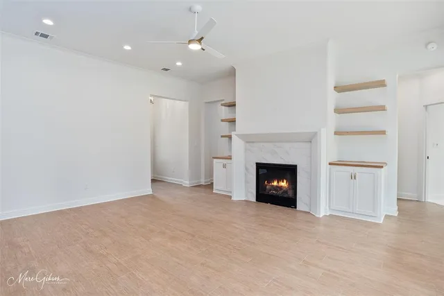 a view of a room with a fireplace and cabinet