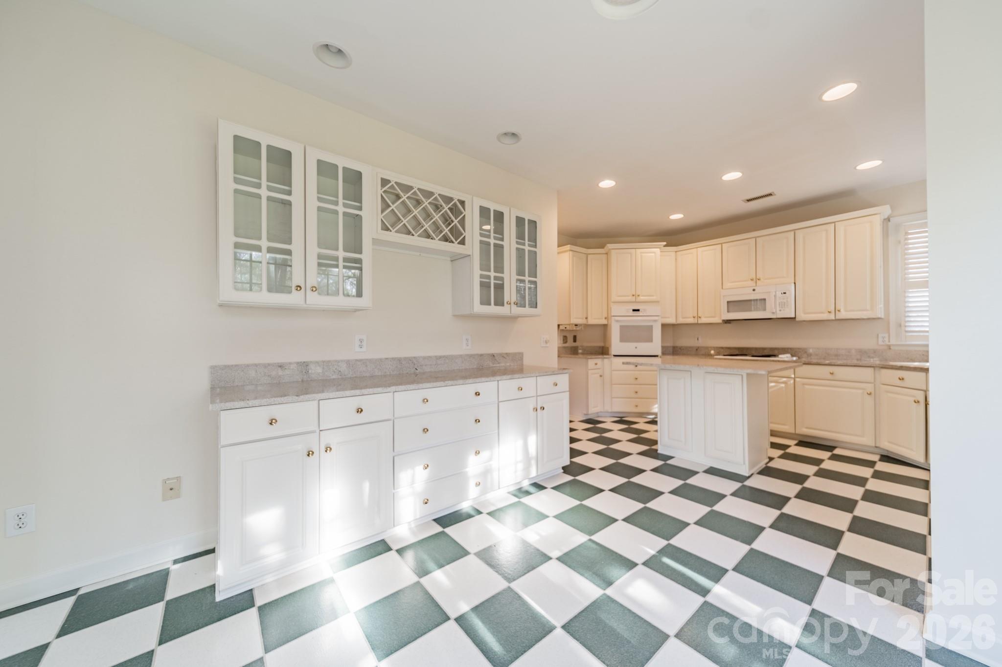 316 Kimberly Road Davidson, NC 28036 - Photo 11 of 37 a kitchen with granite countertop white cabinets and appliances