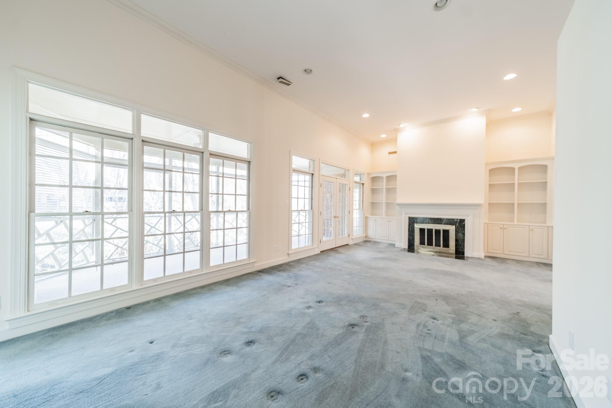 316 Kimberly Road Davidson, NC 28036 - Photo 14 of 37 a view of an empty room with a fireplace and a window