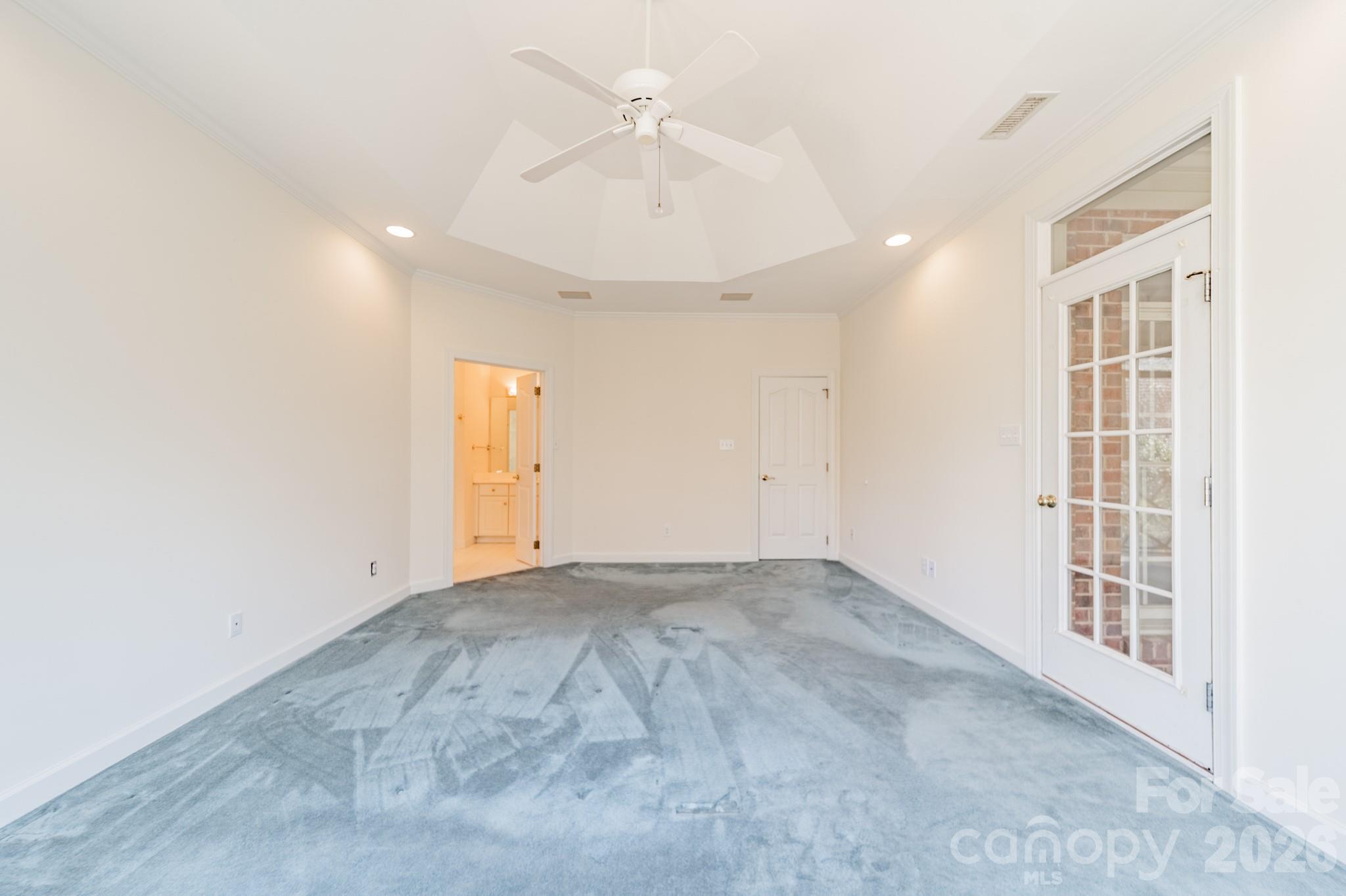 316 Kimberly Road Davidson, NC 28036 - Photo 18 of 37 an empty room with chandelier fan and windows