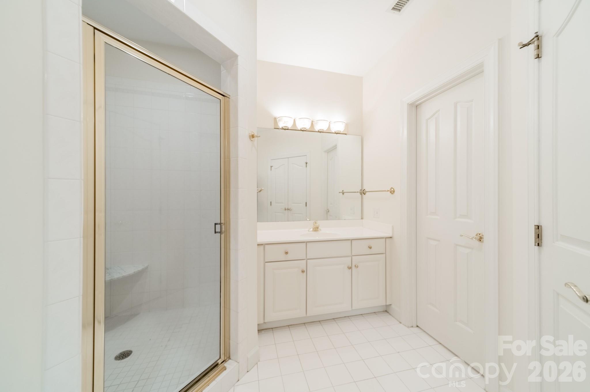 316 Kimberly Road Davidson, NC 28036 - Photo 21 of 37 a spacious bathroom with a shower sink and mirror