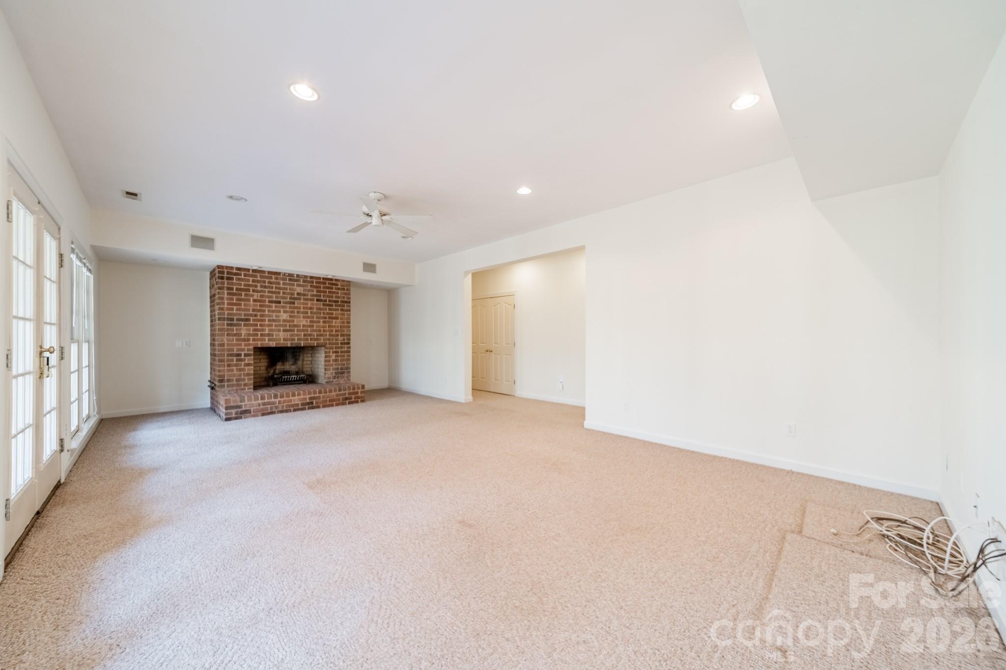 316 Kimberly Road Davidson, NC 28036 - Photo 25 of 37 an empty room with furniture and a fireplace