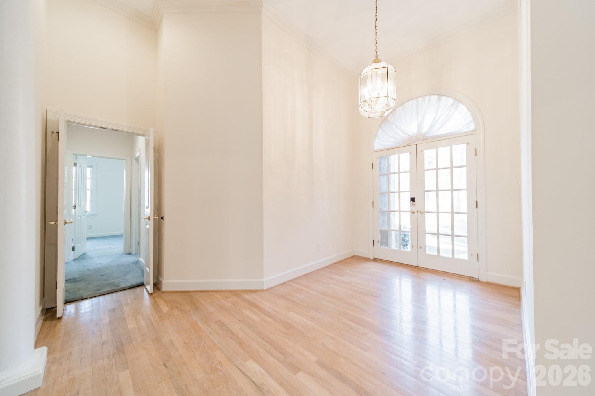 316 Kimberly Road Davidson, NC 28036 - Photo 7 of 37 a view of an empty room with wooden floor and a window