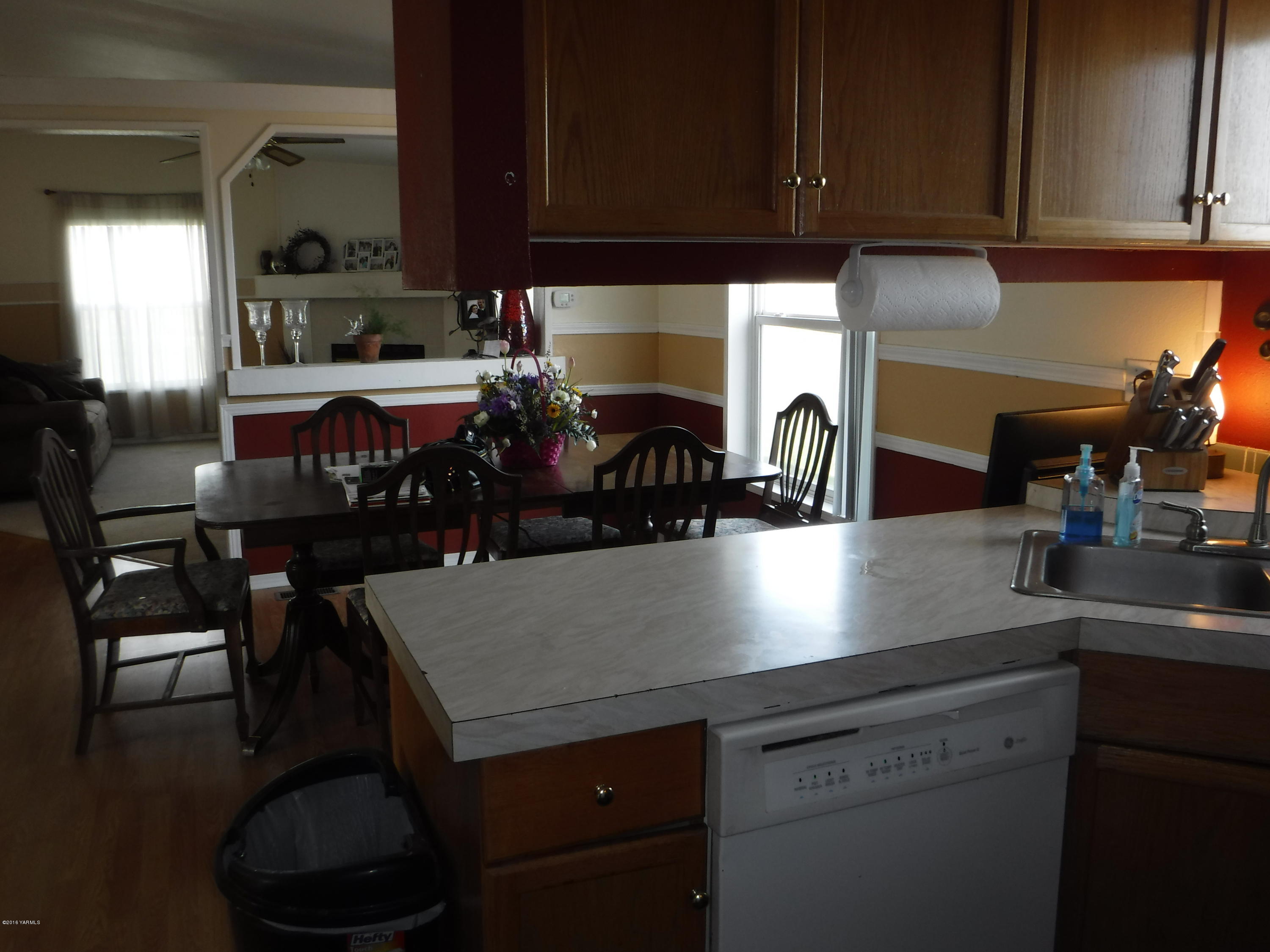 495 Burnham Road Yakima, WA 98908 - Photo 30 of 36 a kitchen with a sink cabinets and dining table