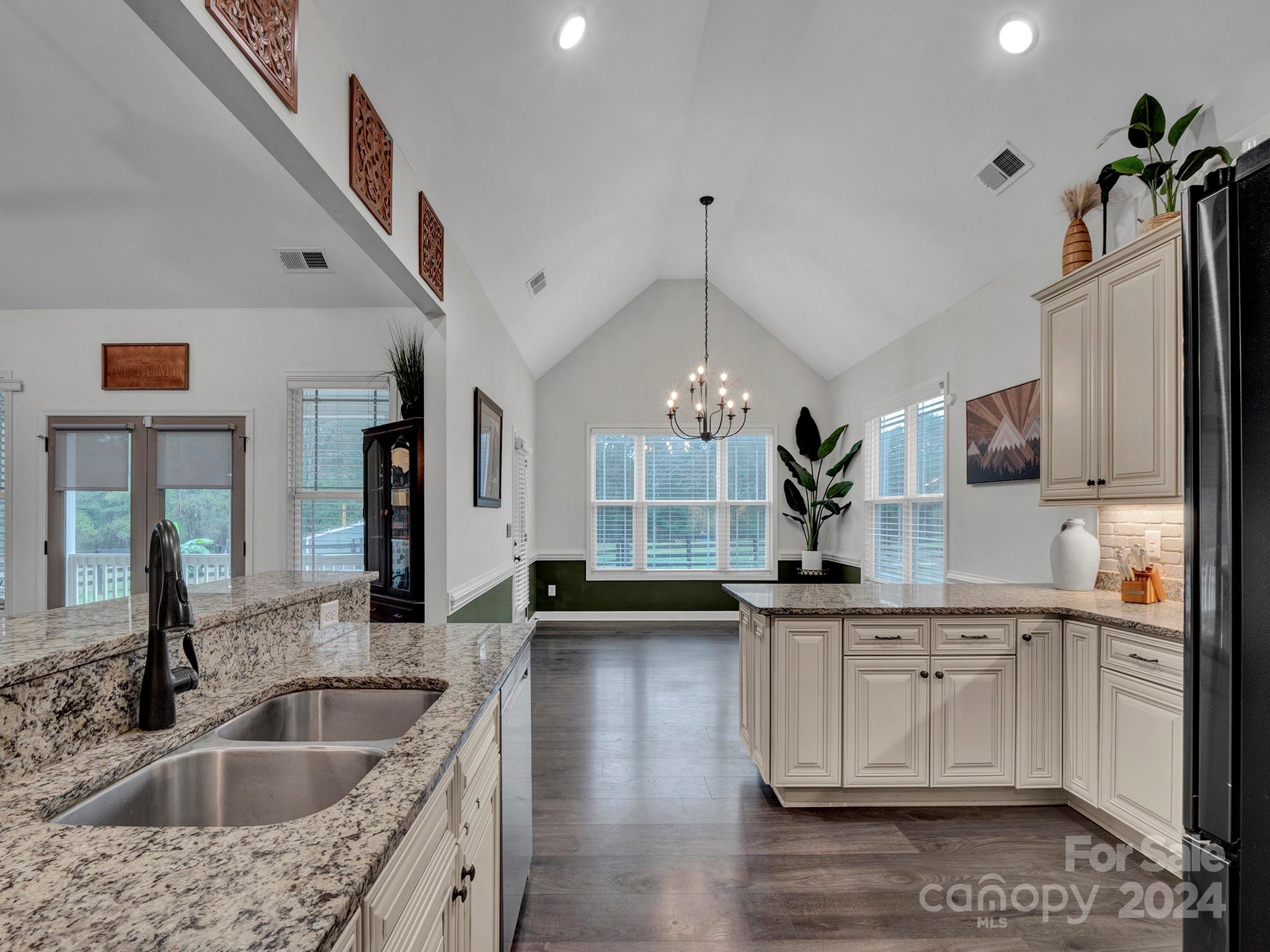 1854 State Rd S-46-168 York, SC 29745 - Photo 21 of 46 a kitchen with stainless steel appliances granite countertop a sink a stove and a wooden floors
