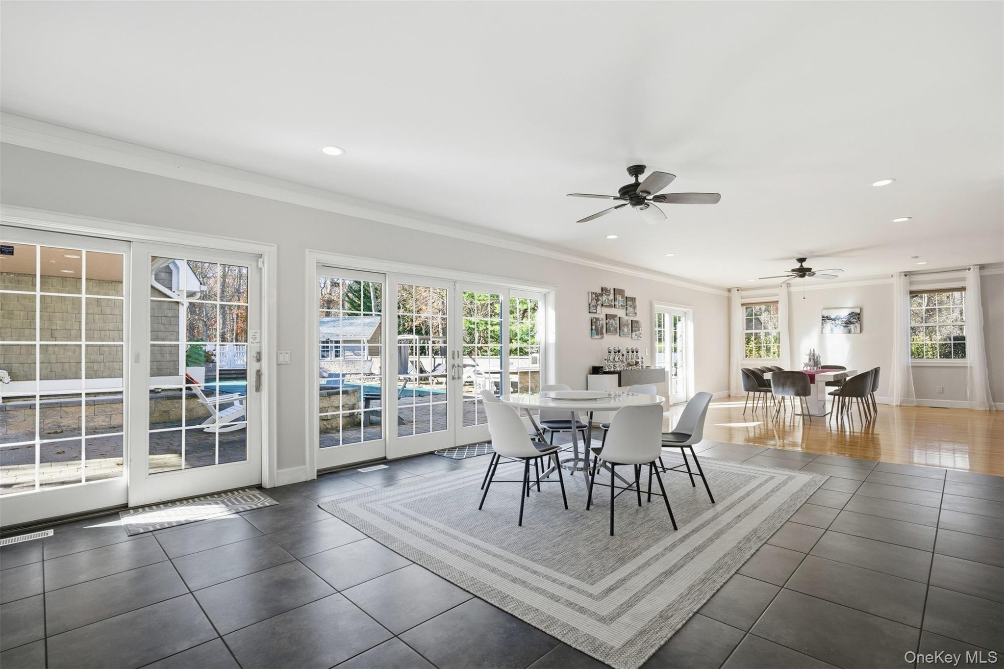 33 A Newtown Road Hampton Bays, NY 11946 - Photo 28 of 50 Dining space featuring crown molding, healthy amount of natural light, recessed lighting, tile patterned floors, and a ceiling fan