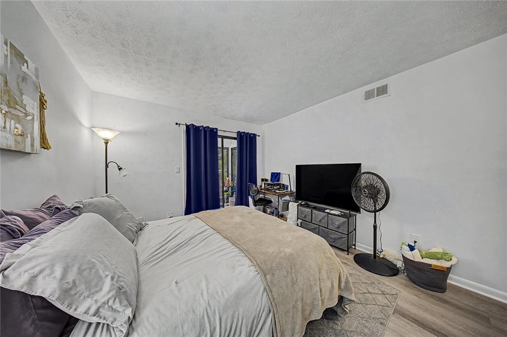 2911 Ironwood Road Southeast Marietta, GA 30067 - Photo 14 of 32 a bedroom with bed tv and chair