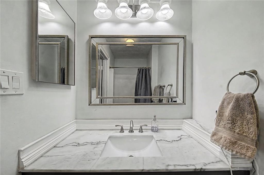 2911 Ironwood Road Southeast Marietta, GA 30067 - Photo 17 of 32 a bathroom with a sink mirror and vanity