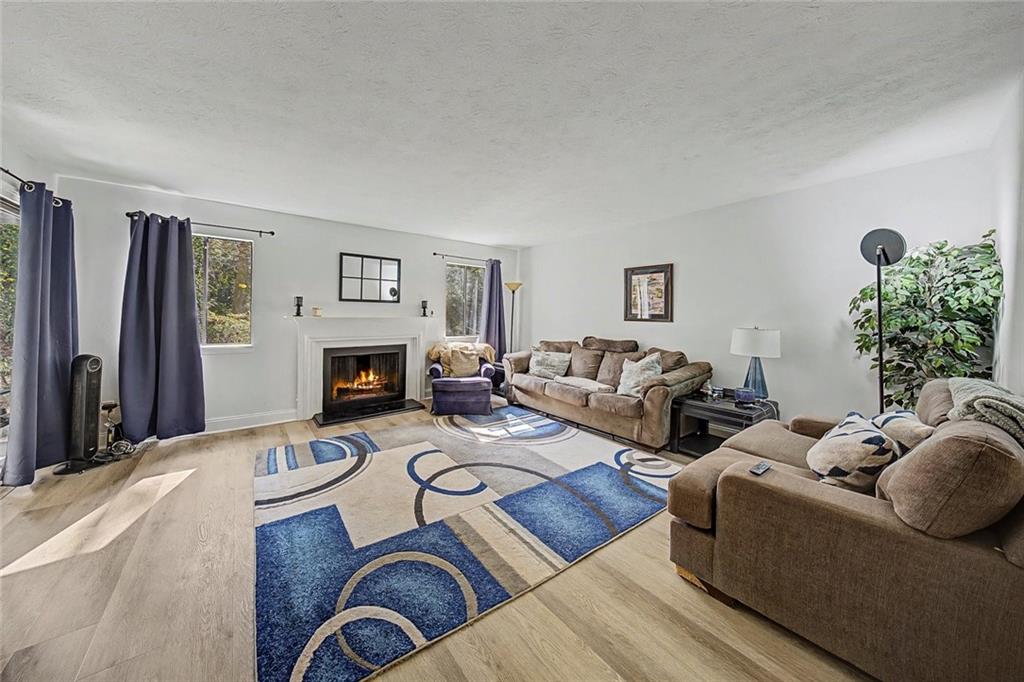 2911 Ironwood Road Southeast Marietta, GA 30067 - Photo 8 of 32 a living room with furniture two window and a fireplace