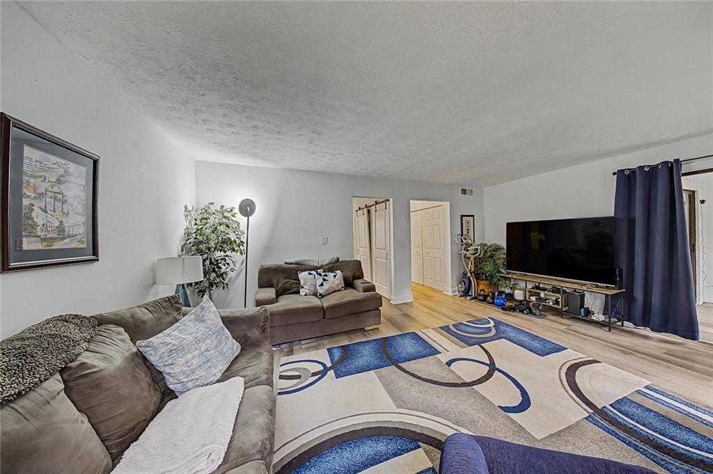2911 Ironwood Road Southeast Marietta, GA 30067 - Photo 10 of 32 a living room with furniture and a flat screen tv
